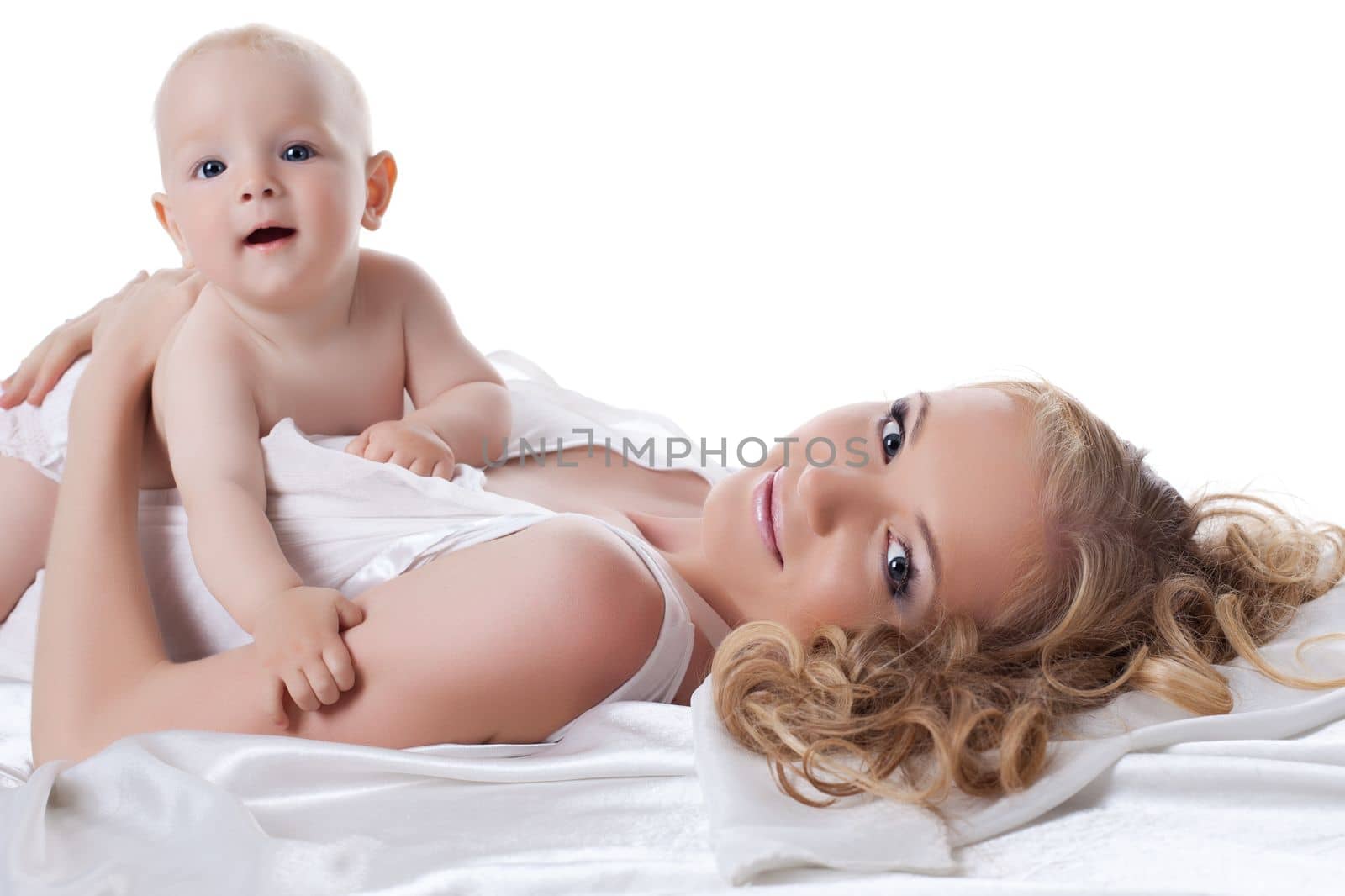 Happy mother and baby in bed by rivertime