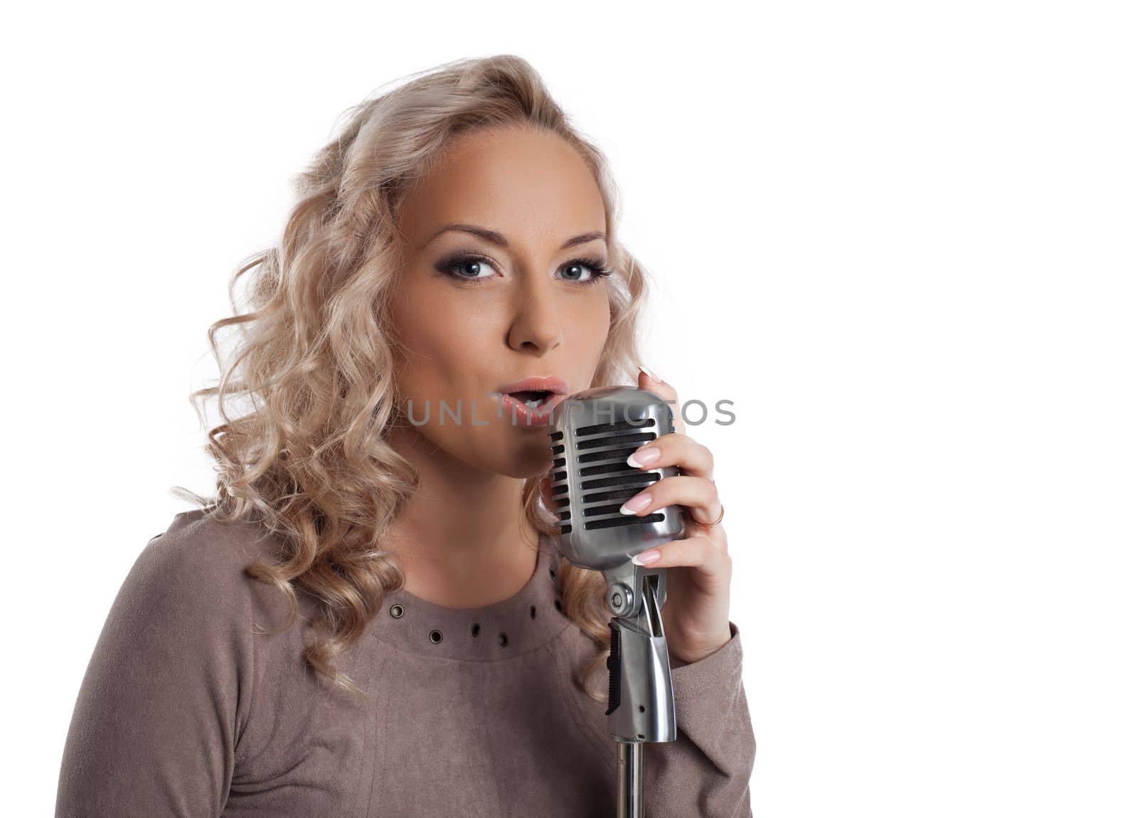 Pretty blonde woman with vintage microphone. Isolated on white