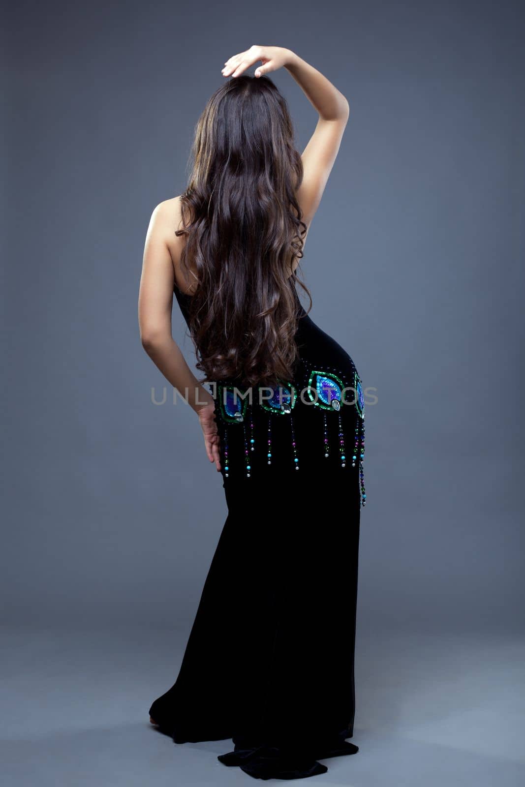 Full length portrait of beautiful oriental dancer with long hair