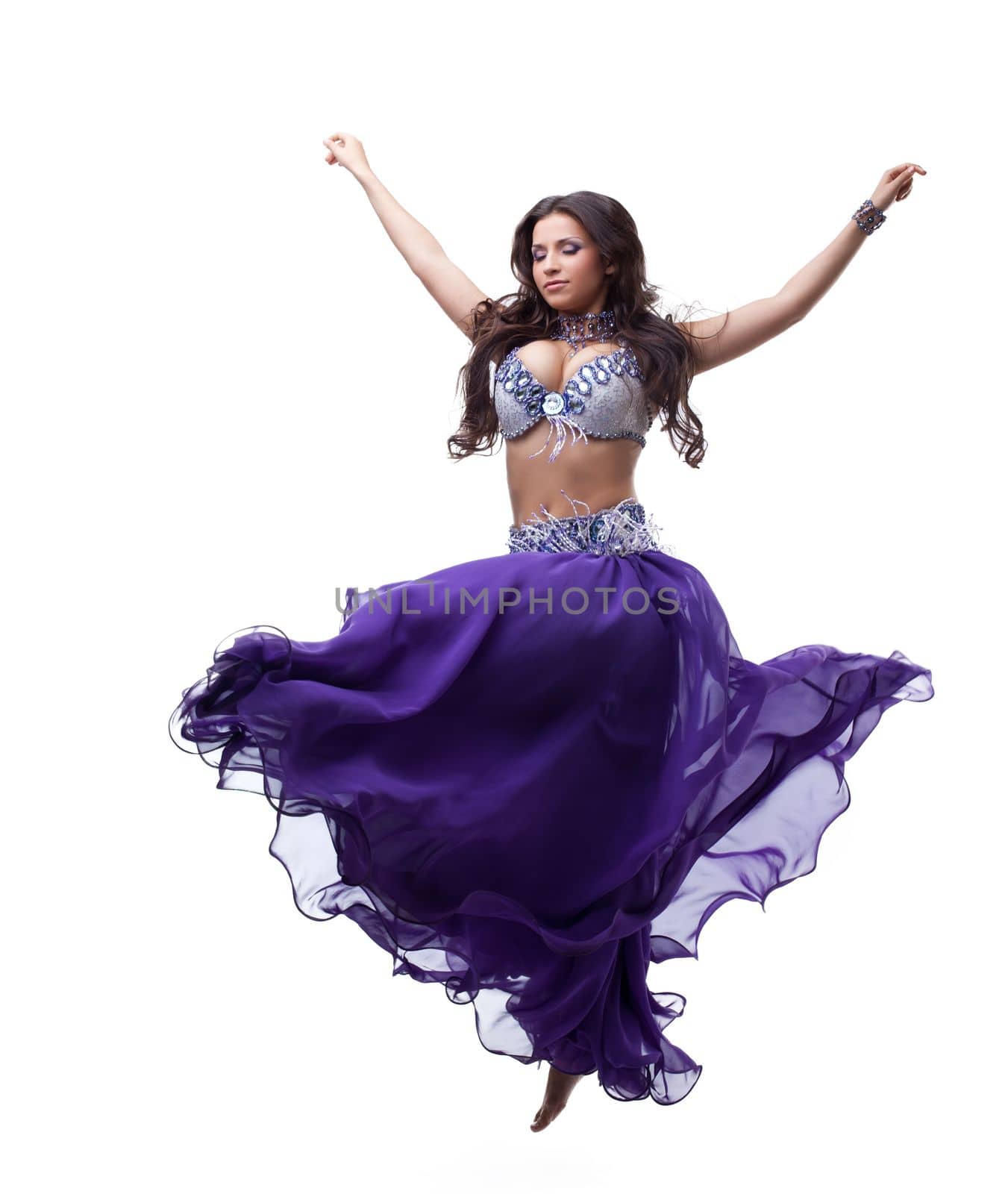 Full length portrait of oriental dancer in purple costume. Isolated on white