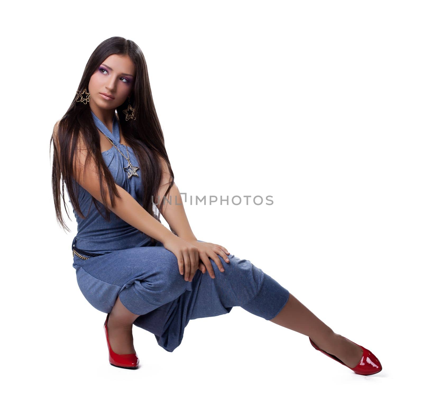 Brunette young woman in overalls. Isolated on white