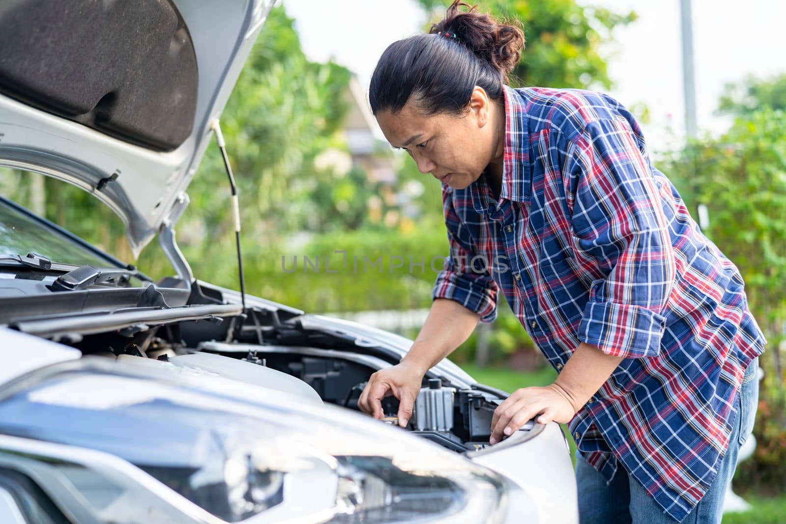 Open hood mechanic engine system to check and repair damage car crash.