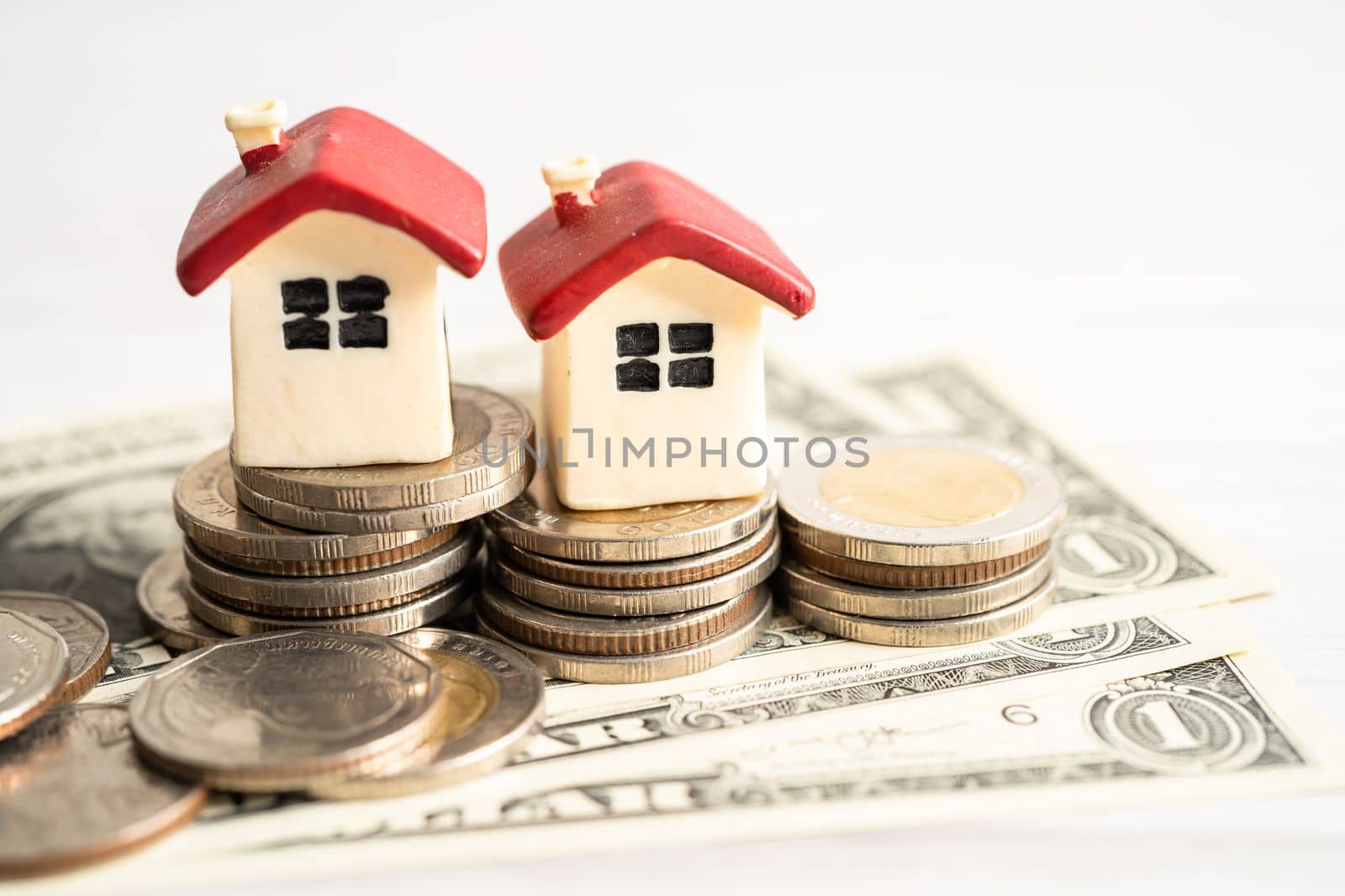 House model with growing plant on stack of coin money, home loan, saving plan, installment payment finance and banking concept.
