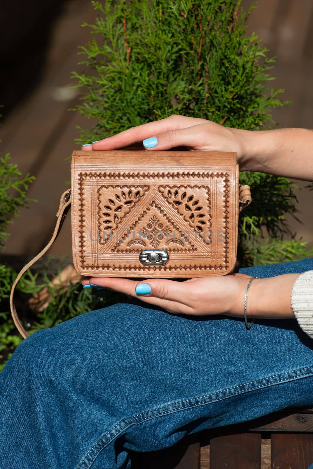 small light brown women's leather bag with a carved pattern. street photo by Ashtray25