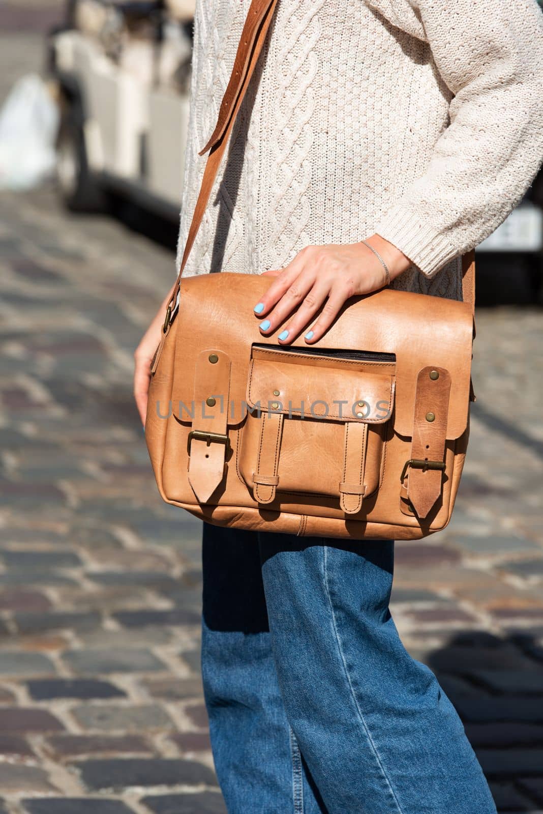 Woman with a yellow leather briefcase with antique and retro look. Outdoors photo.