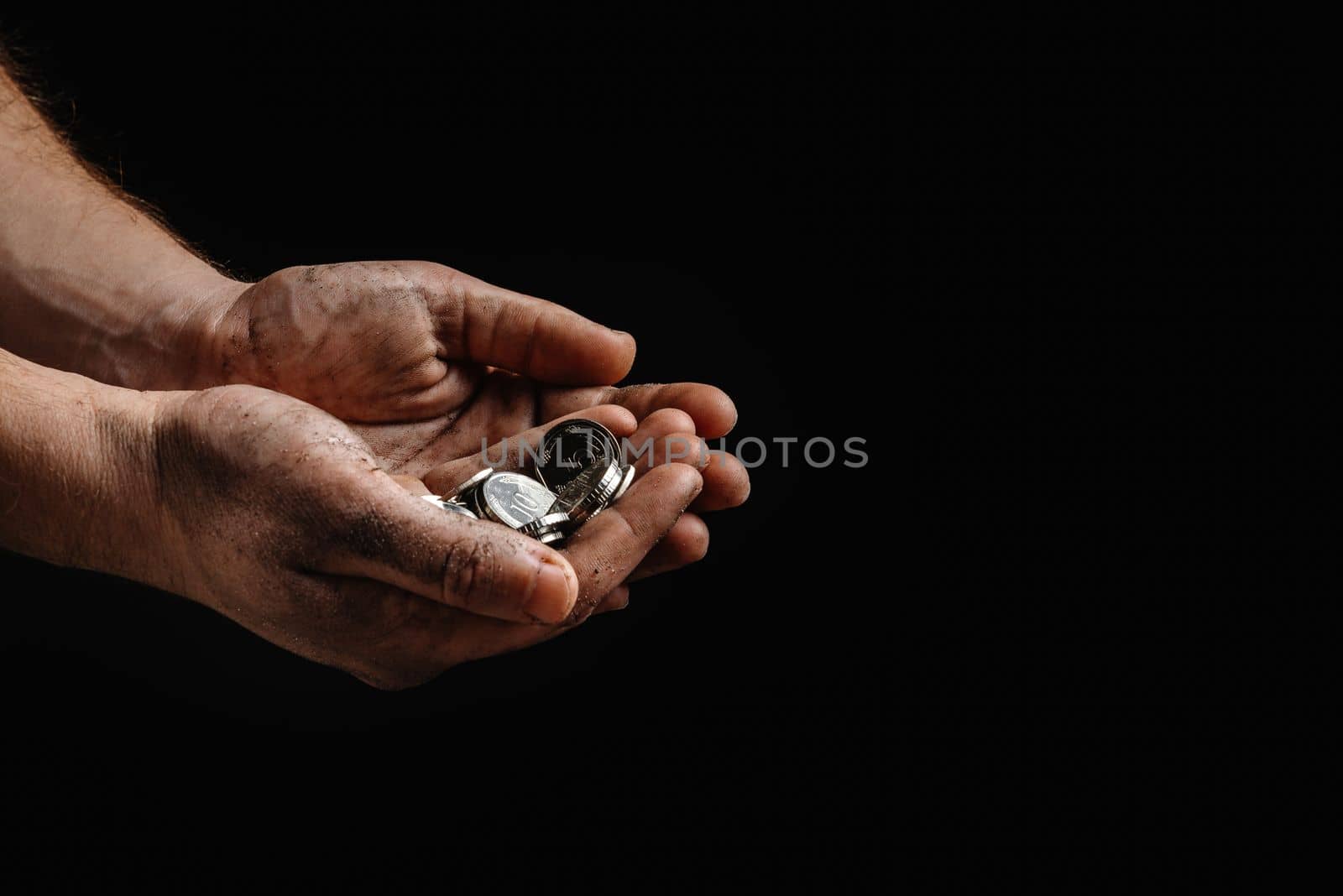 homeless outreach day. Dirty hands of a homeless man holding not much money against a black background. The concept of financial aid by gulyaevstudio