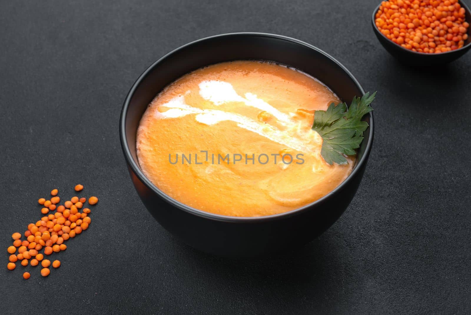 Red lentil soup on a dark background top view. Traditional Middle Eastern, Turkish, Ramadan cuisine. Vegan Cuisine by gulyaevstudio