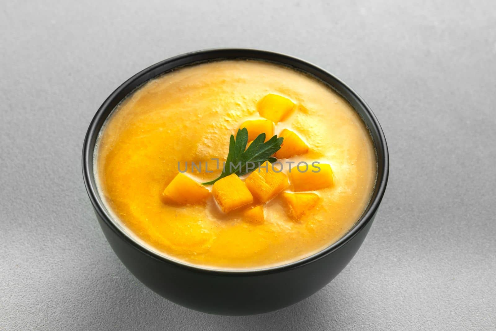 pumpkin cream soup mashed potatoes on a gray background by gulyaevstudio