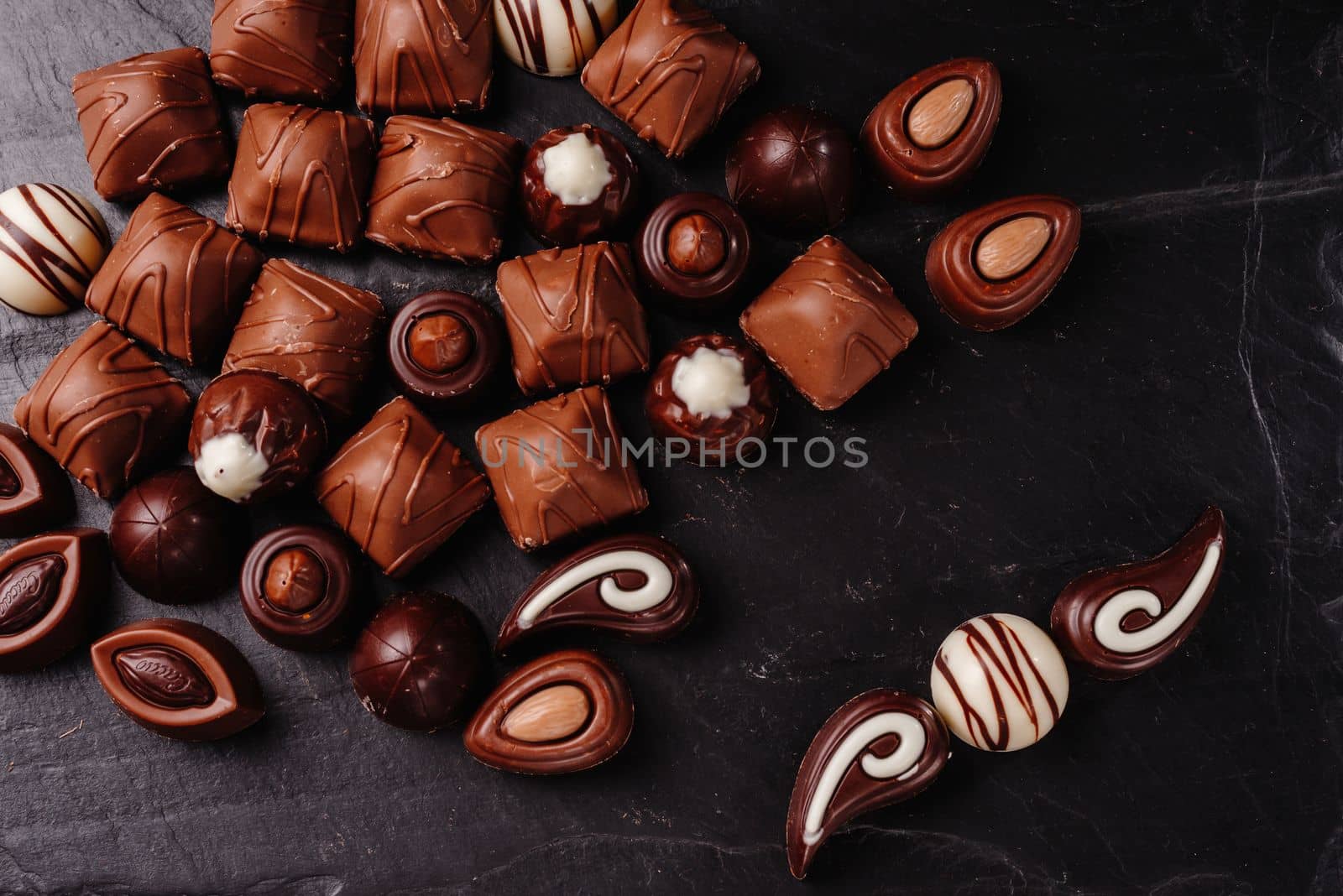chocolate candies with various fillings, sweet food background. mix and match set of different candies. chocolates with different fillings, sweet food background. Copy space. by gulyaevstudio