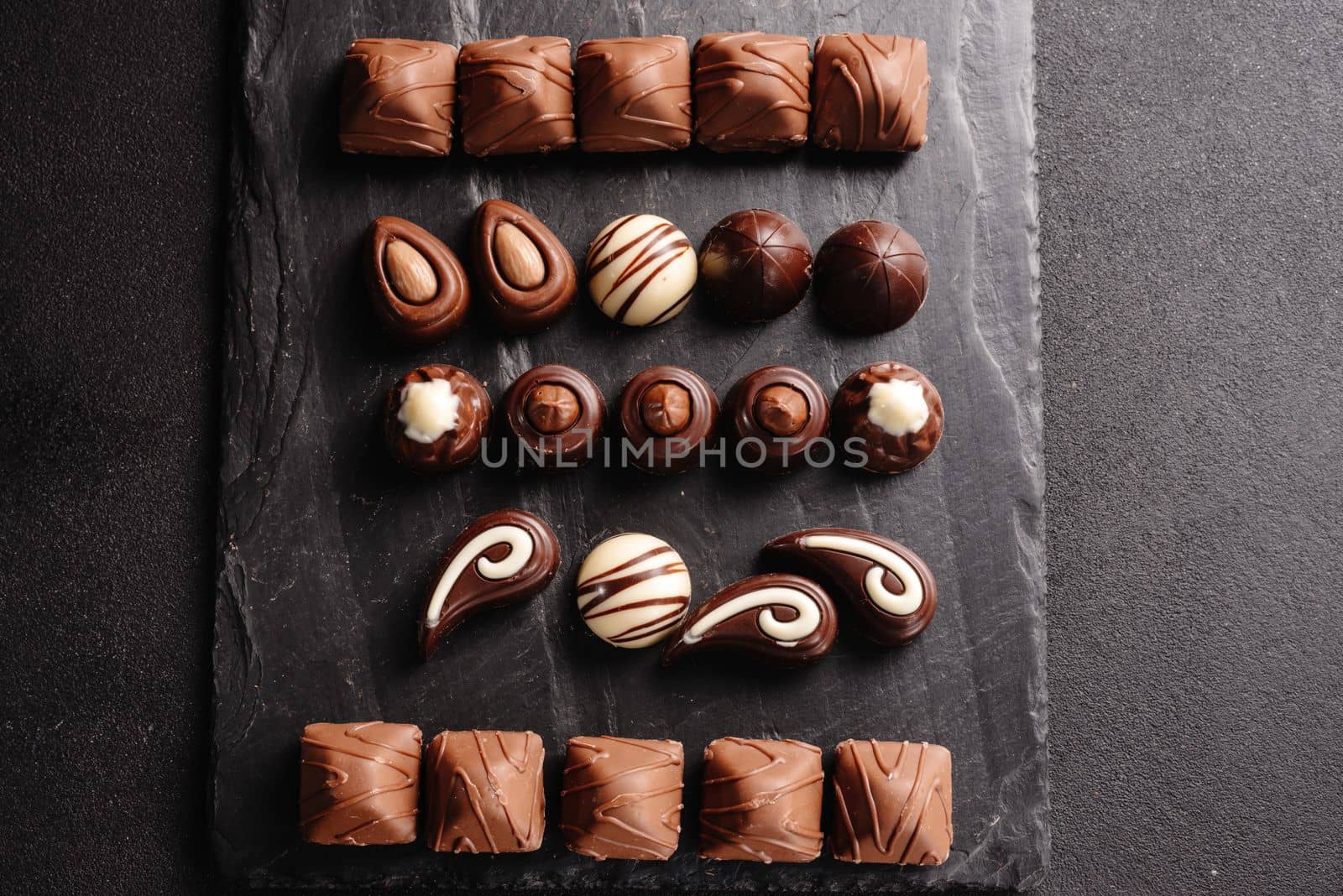 chocolate candies with various fillings, sweet food background. mix and match set of different candies. chocolates with different fillings, sweet food background.