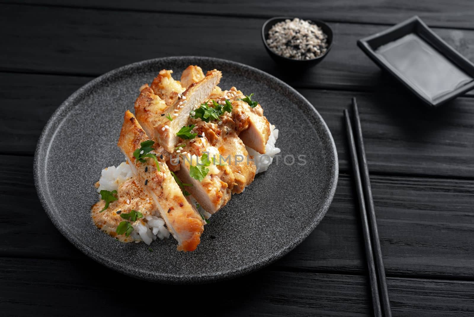 Asian cuisine dish with rice and chicken. Nasi Hainan or Hainan chicken. Hainan chicken rice is a dish of poached chicken and seasoned rice. Top view and dark wooden background