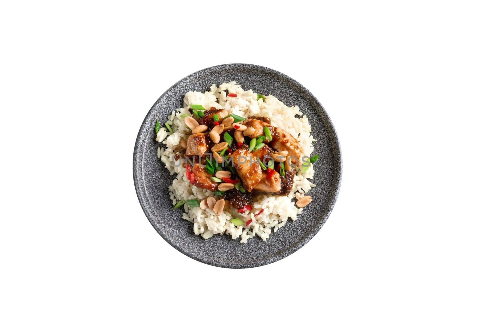 Kung Pao chicken. Isolate. Gong Bao Ji Ding on a dark concrete background. Sichuan kung pao is a Chinese dish with chicken meat, chili peppers, peanuts, sauces, and onions. Copy place. Top view.