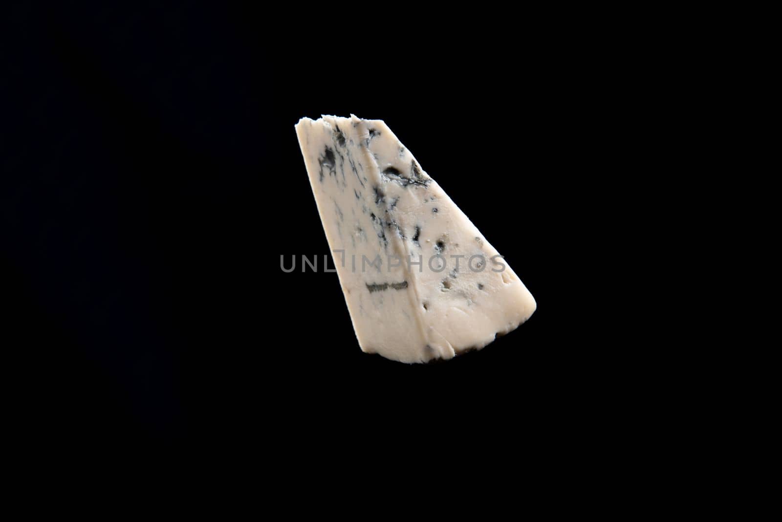 Blue cheese, dor bleu or Roquefort mold cheese on black isolate, lifestyle food by gulyaevstudio