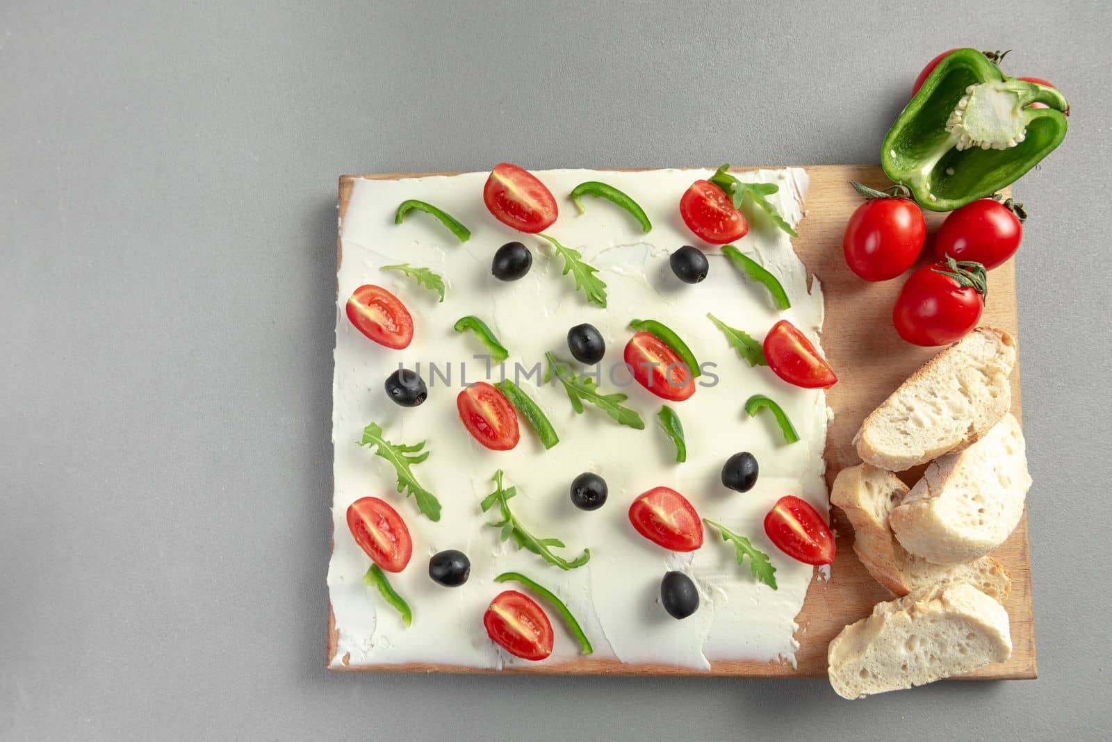 A board of butter or cream cheese on a wooden board. Appetizer. Top view. Butter board food trend, cracker with butter.