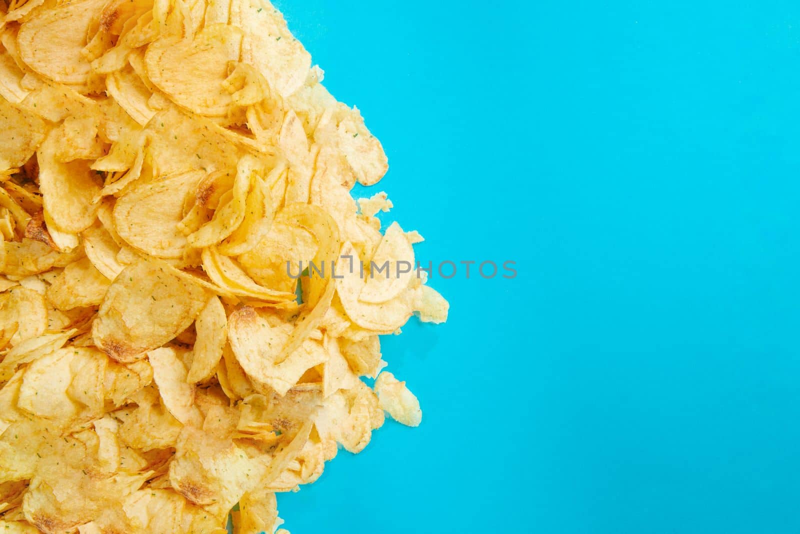 Fried foods are bad for your health. Healthy Eating. Chips, fried potatoes. Unhealthy foods. Blank space for text. Harmful food. Fried potatoes and chips on a blue background. Fried food is bad for your health. by gulyaevstudio