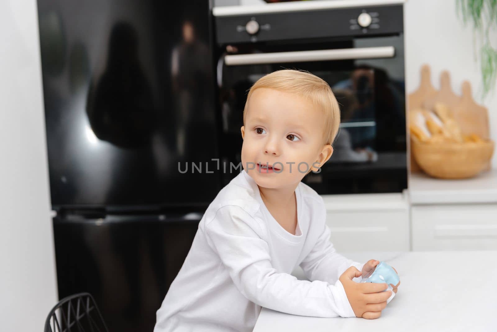 A cute little boy. Portrait of a child in the kitchen.