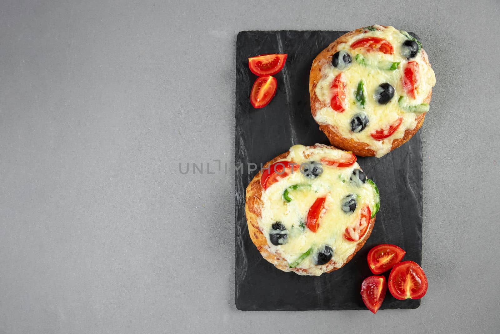 Indian tortillas, homemade pizza in India on a gray background. Blank space for text. Copy space