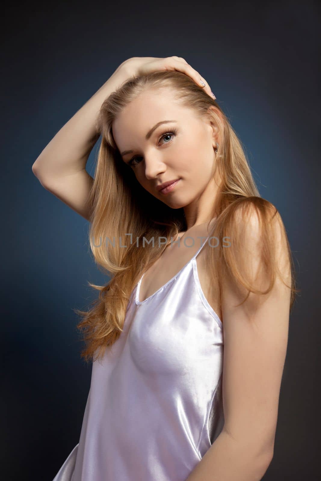 Amazing woman studio portrait in white on blue