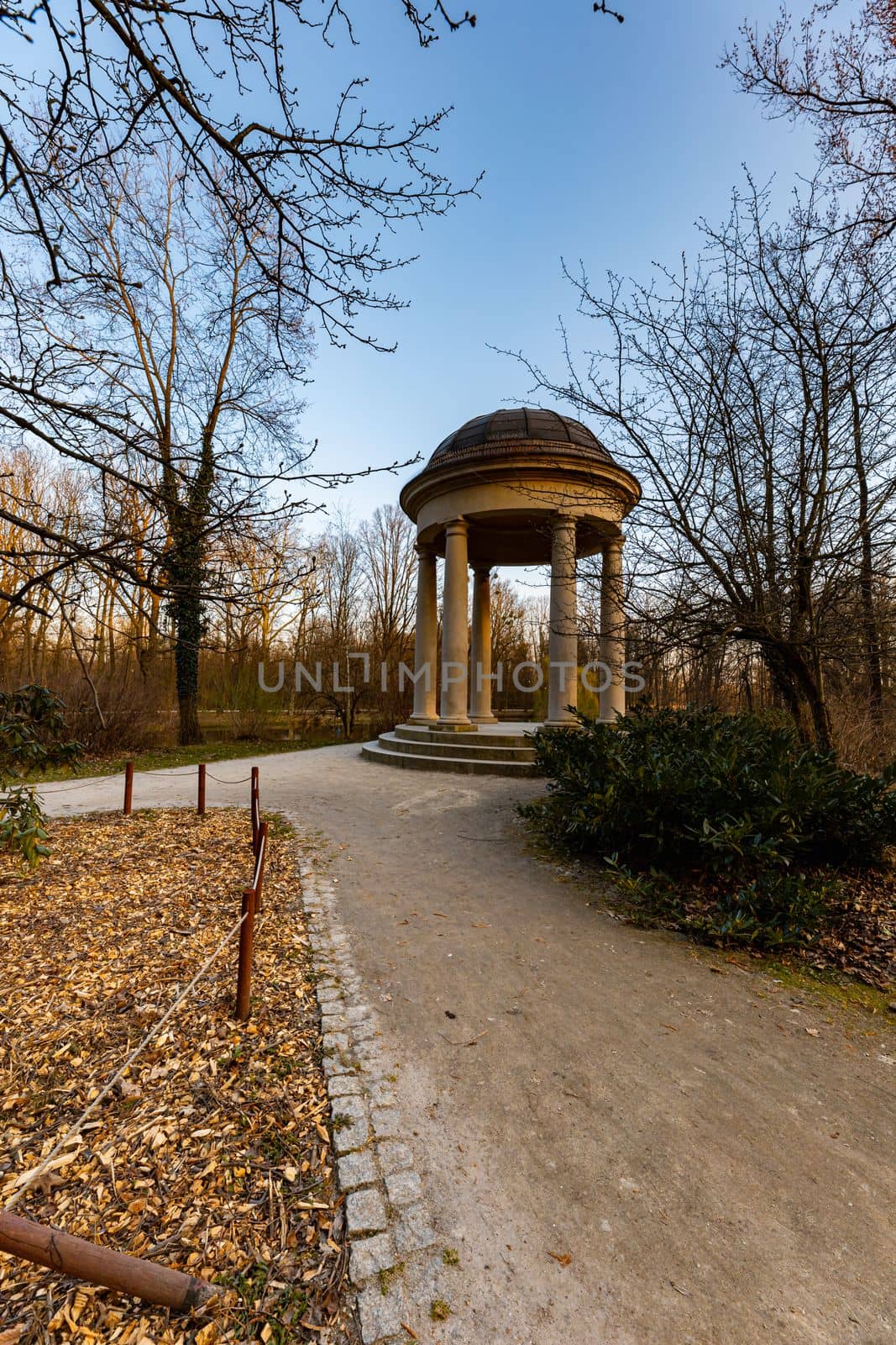 Small beautiful bower Glorieta at the edge next to small pond in park by Wierzchu