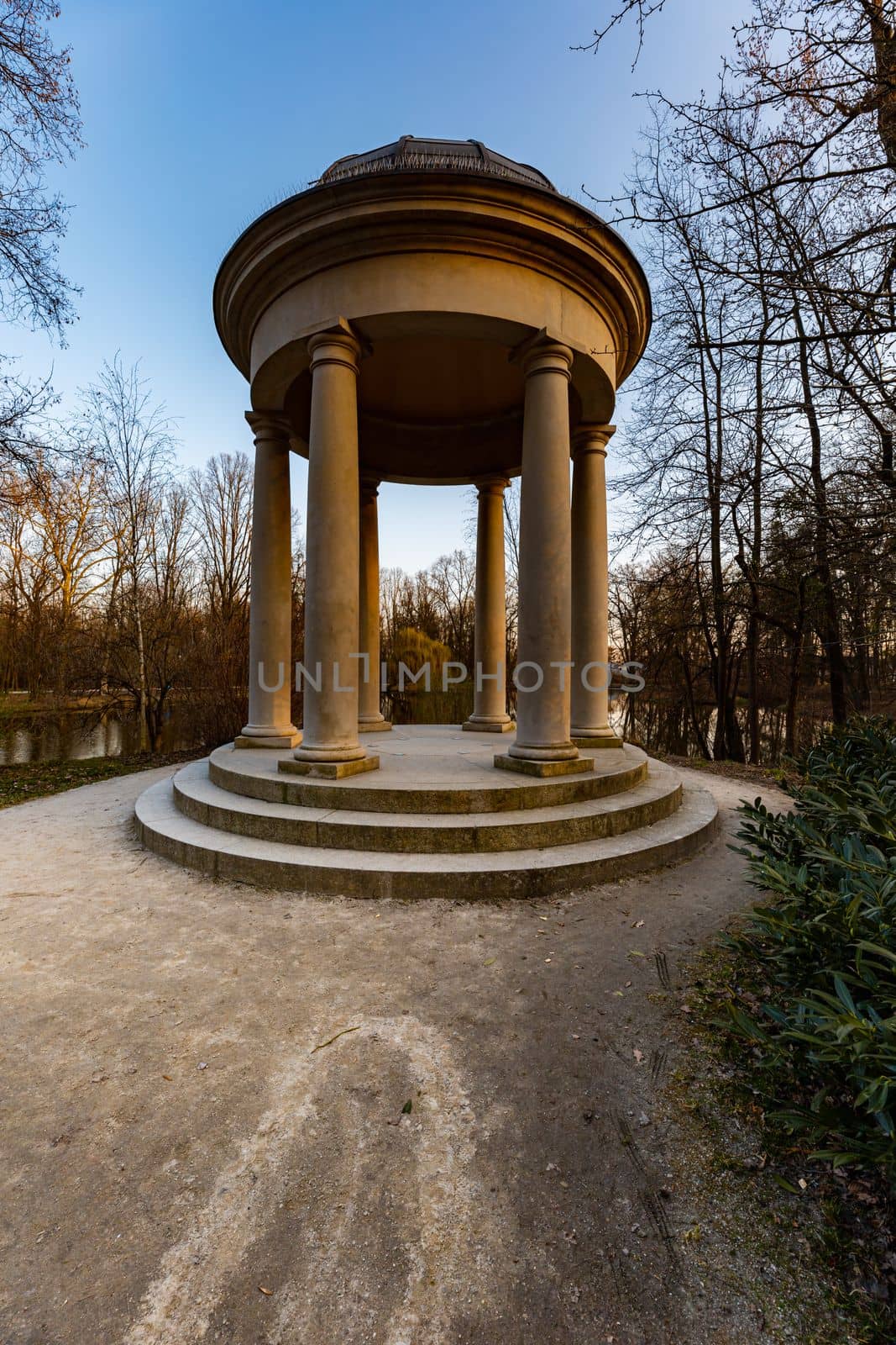 Small beautiful bower Glorieta at the edge next to small pond in park by Wierzchu