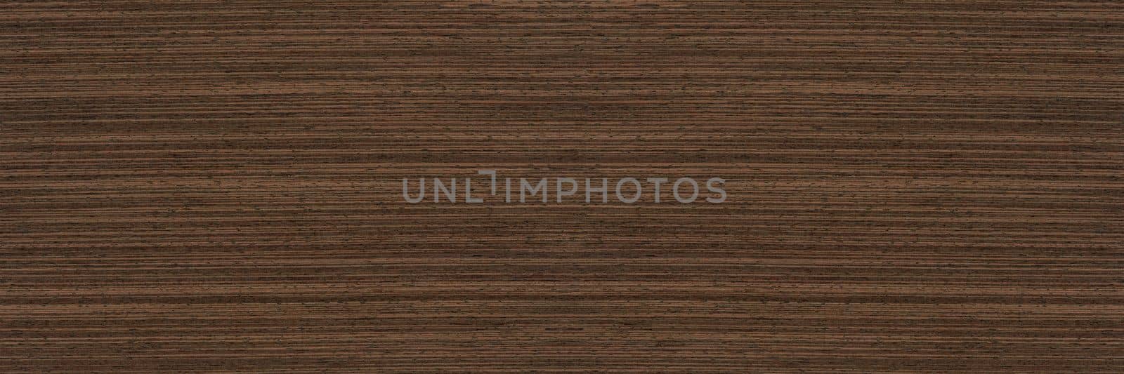 Texture of wenge wood. Dark brown wood for furniture or flooring. Close-up of a Wenge wooden plank, top view