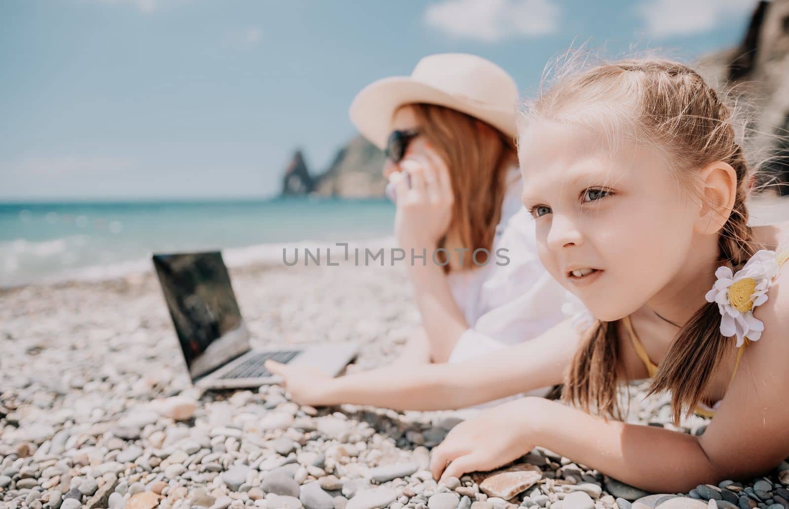 Woman sea laptop. Business woman in yellow hat working on laptop by sea. Close up on hands of pretty lady typing on computer outdoors summer day. Freelance, digital nomad, travel and holidays concept.