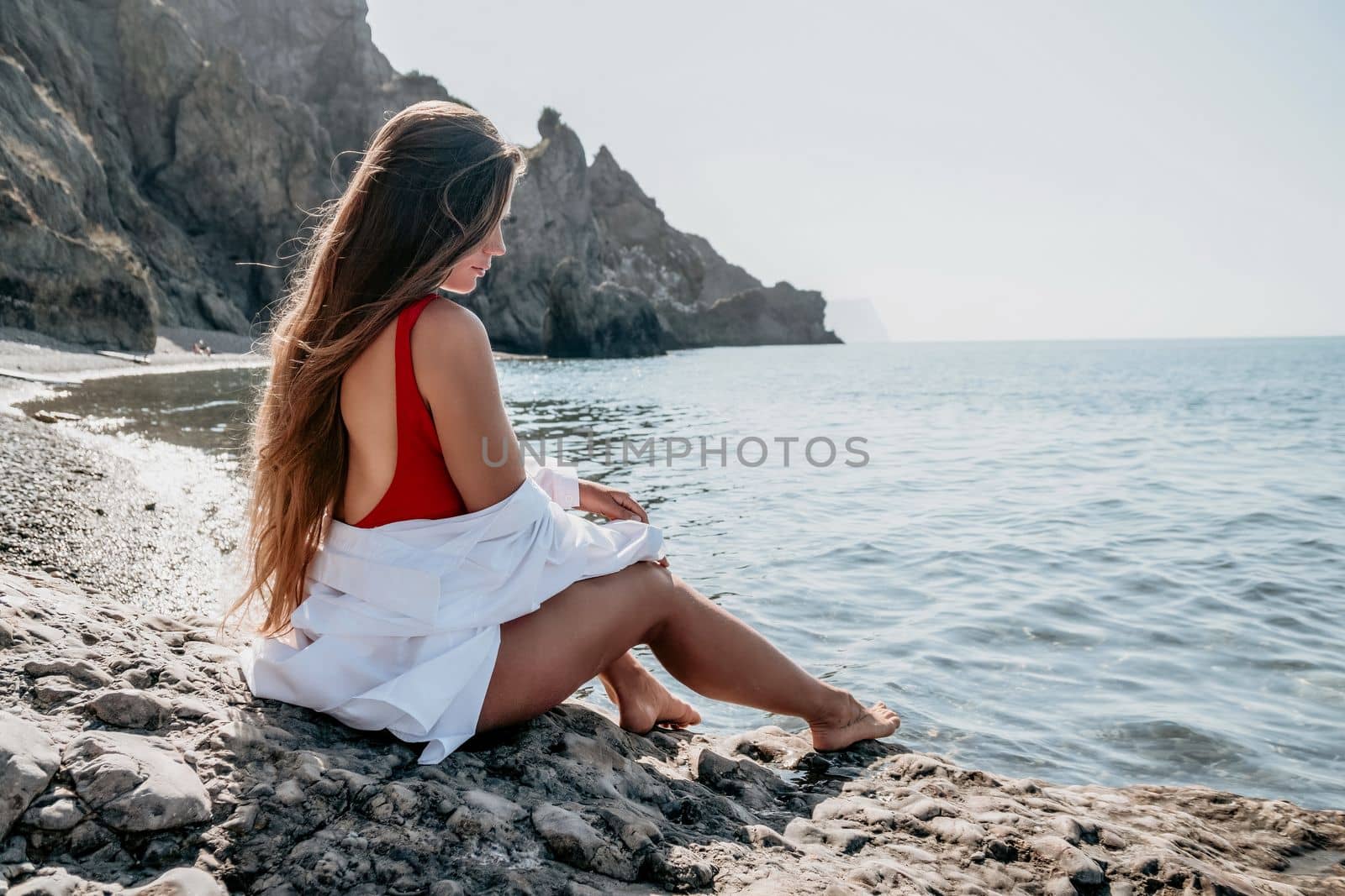 Sexy young woman in stylish bikini lying on seashore, closeup. Holiday, vacation and recreational concept.