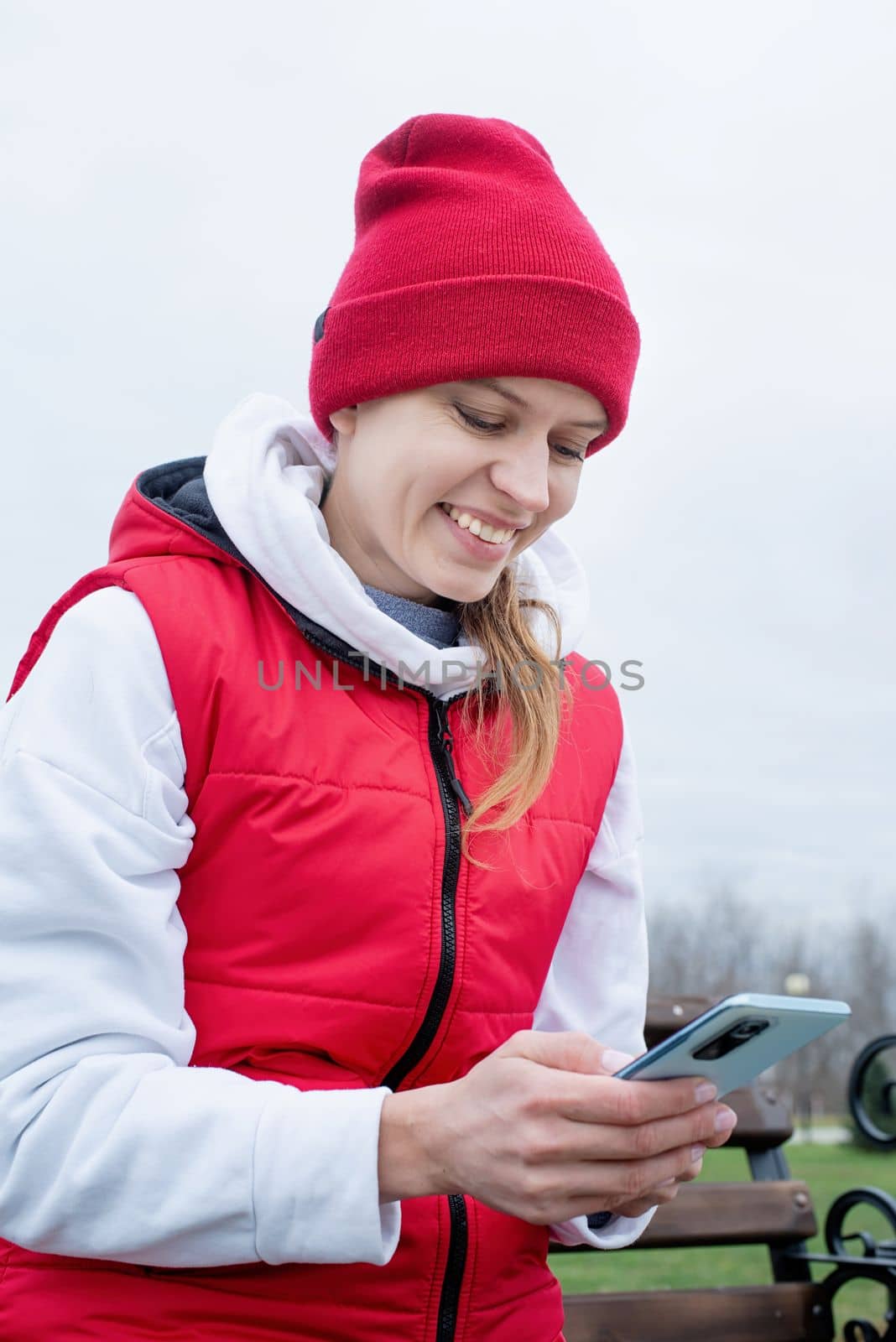 Woman wearing sport clothes and knee brace or orthosis after leg surgery, walking down the stairs in the park. Medical and healthcare concept.