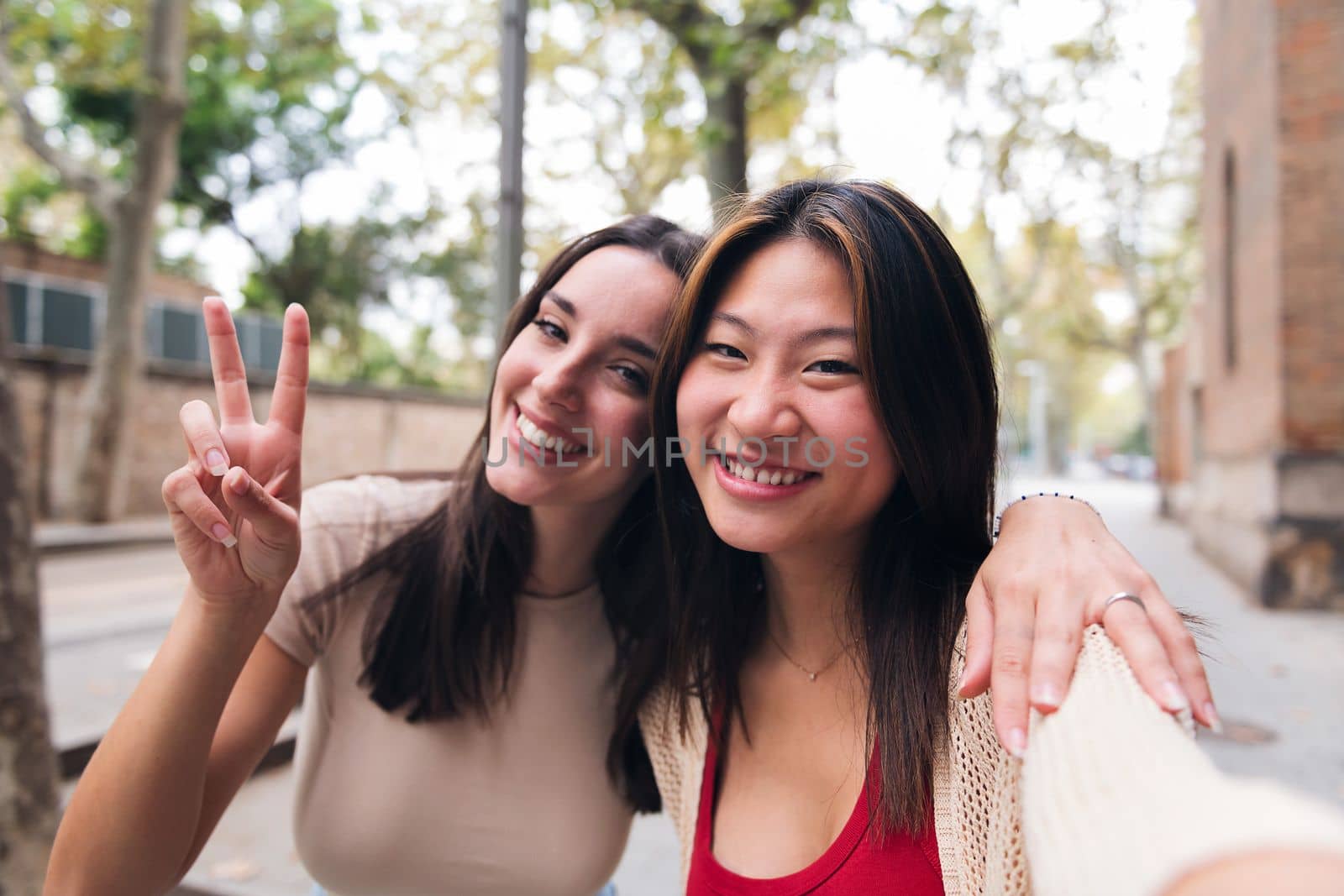 selfie of two young women smiling happy and having fun while they date, concept of friendship and love between people of the same sex