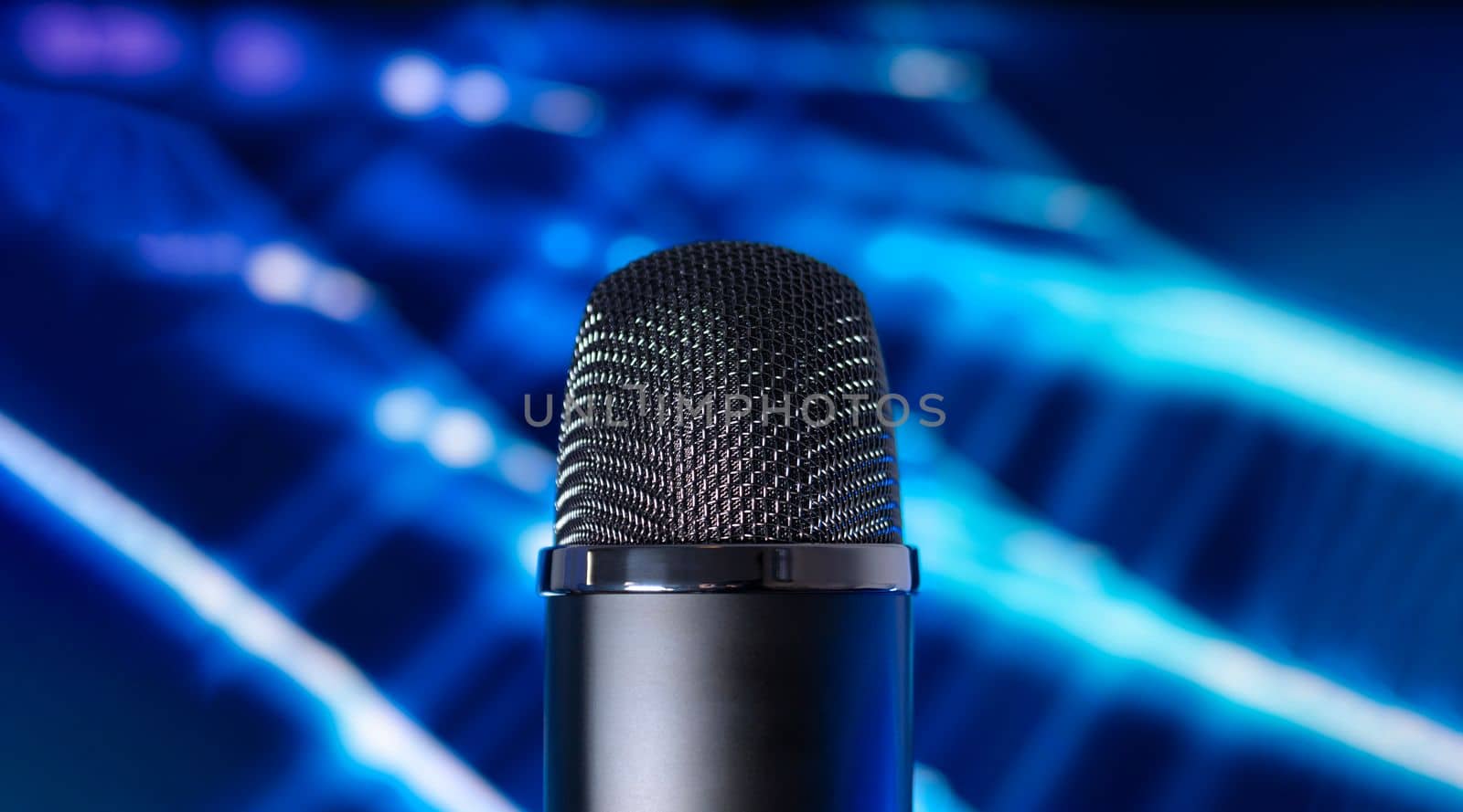 Condenser microphone on a blue tech background. Concept recording audio podcast.