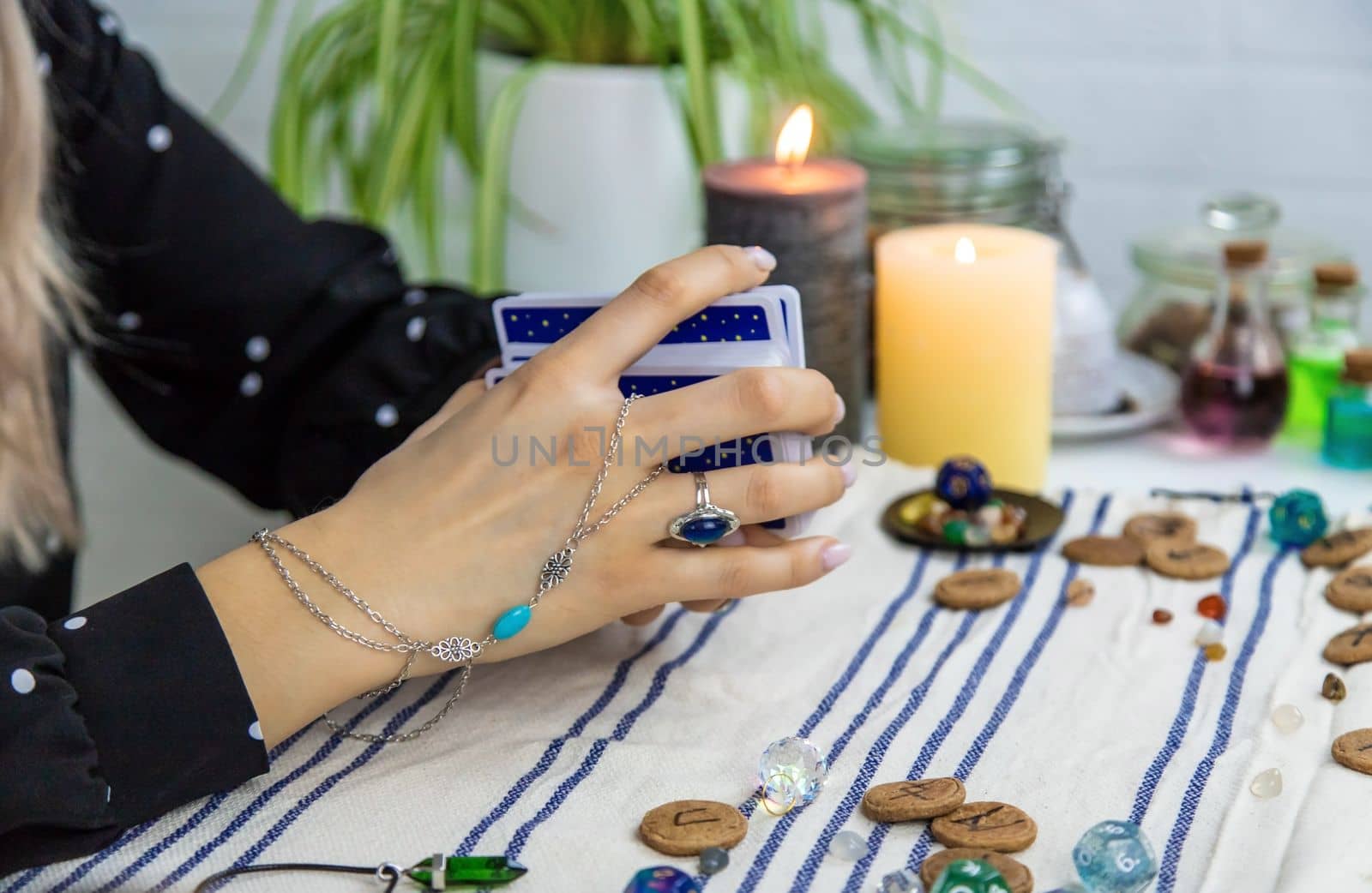 A fortune teller reads with tarot cards. Selective focus. Woman.