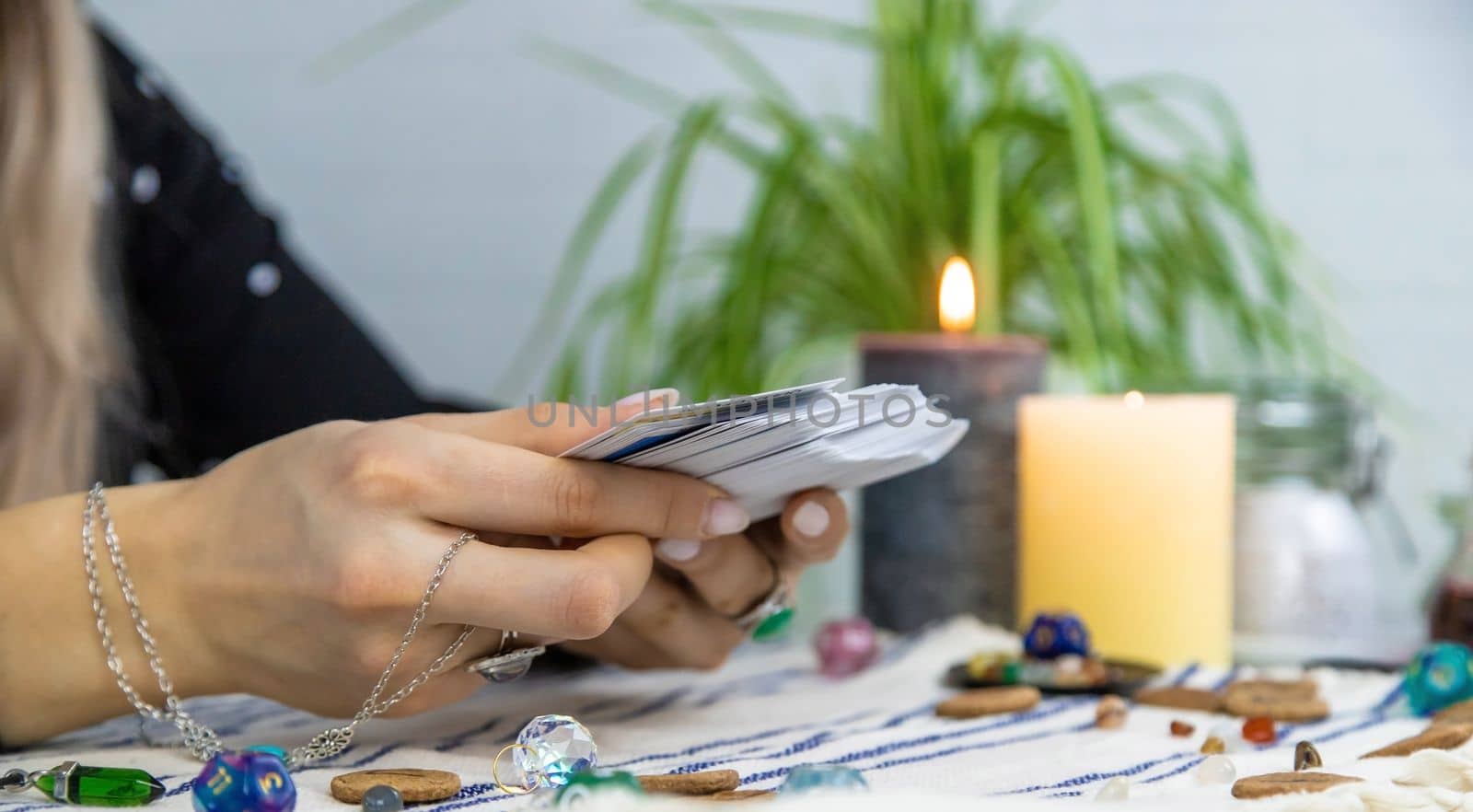 A fortune teller reads with tarot cards. Selective focus. Woman.