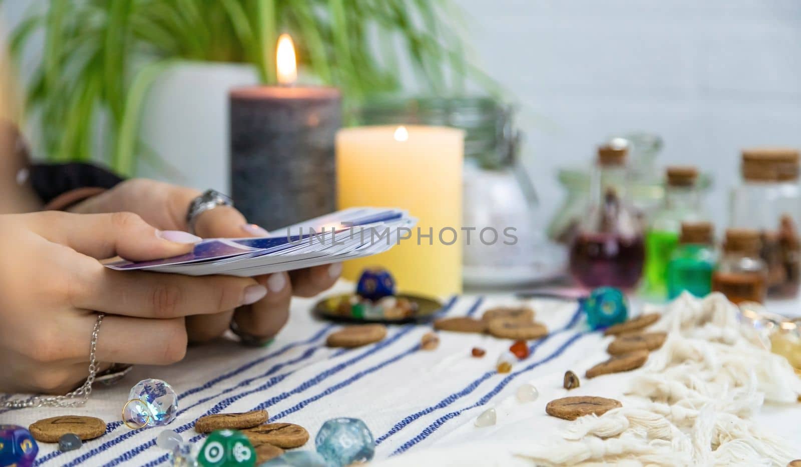 A fortune teller reads with tarot cards. Selective focus. Woman.