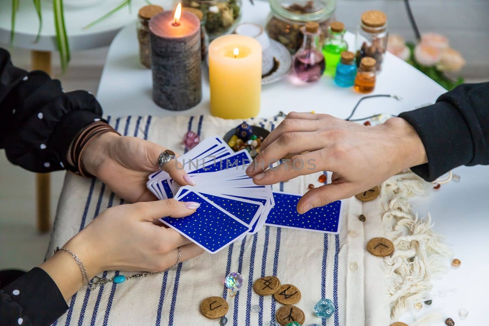 A woman fortuneteller tells a man on tarot cards. Selective focus. People.