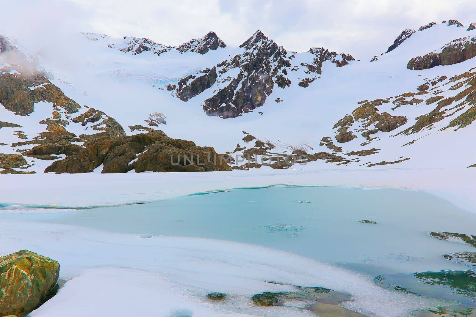Melting frozen and peaceful lake, Andes landscape in Tierra Del fuego, Ushuaia, Argentina, South America