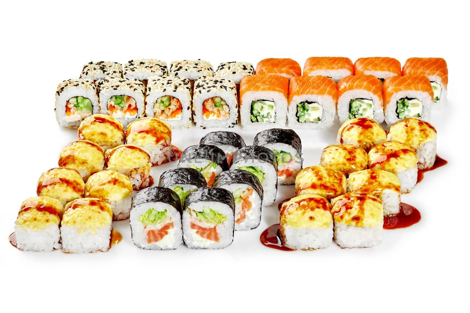 Appetizing set of various sushi rolls with salmon, tobiko roe, cream cheese and vegetables for family dinner in Japanese style on white background. Popular snacks concept