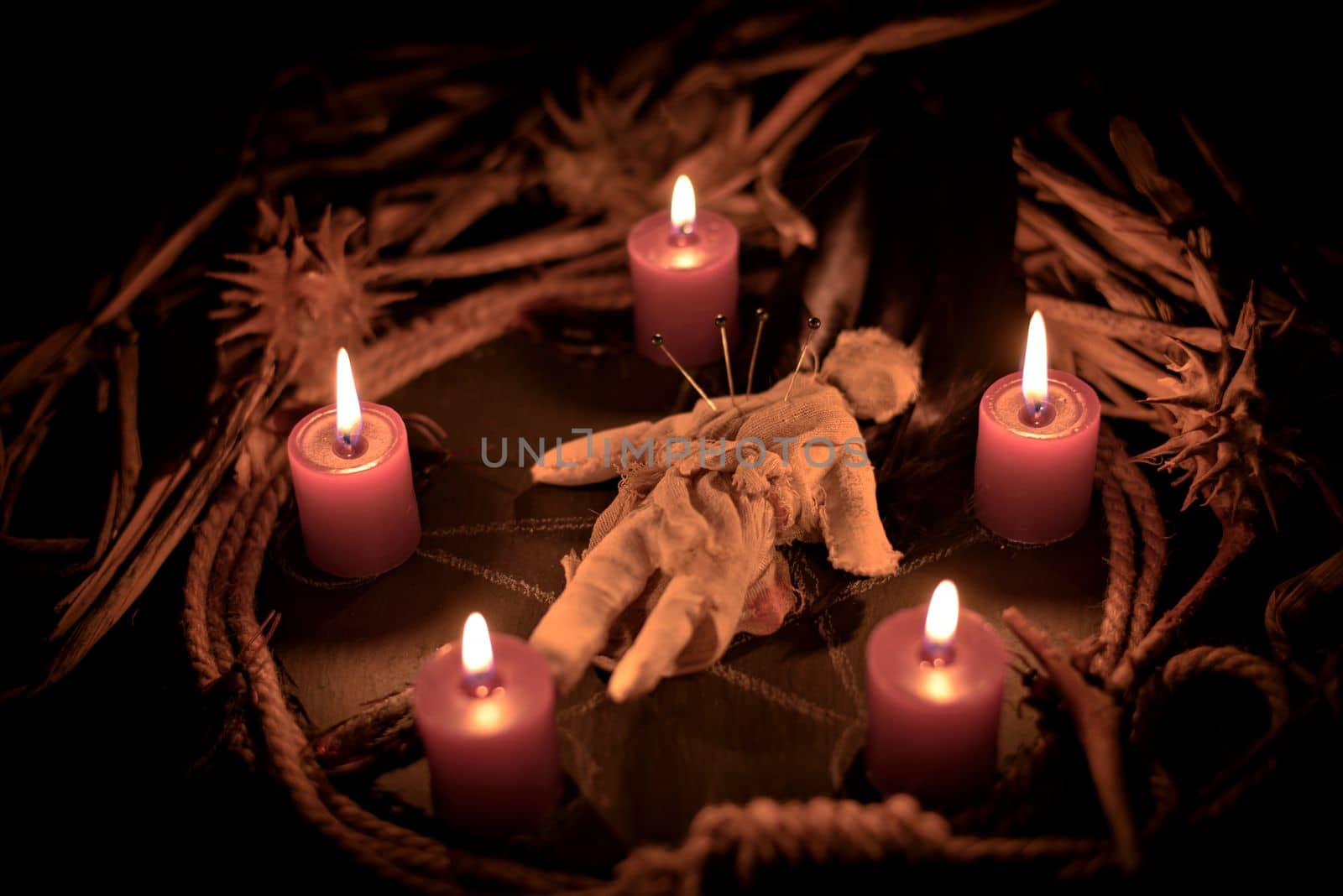 Pentagram amulet and black candle in autumn forest, natural background. Magic esoteric witches ritual. Mysticism, divination, wicca, occultism, witchcraft concept. Samhain sabbat