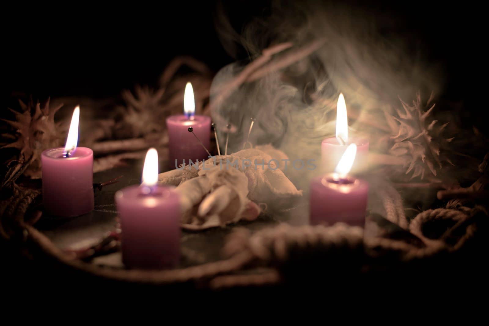 Pentagram amulet and black candle in autumn forest, natural background. Magic esoteric witches ritual. Mysticism, divination, wicca, occultism, witchcraft concept. Samhain sabbat