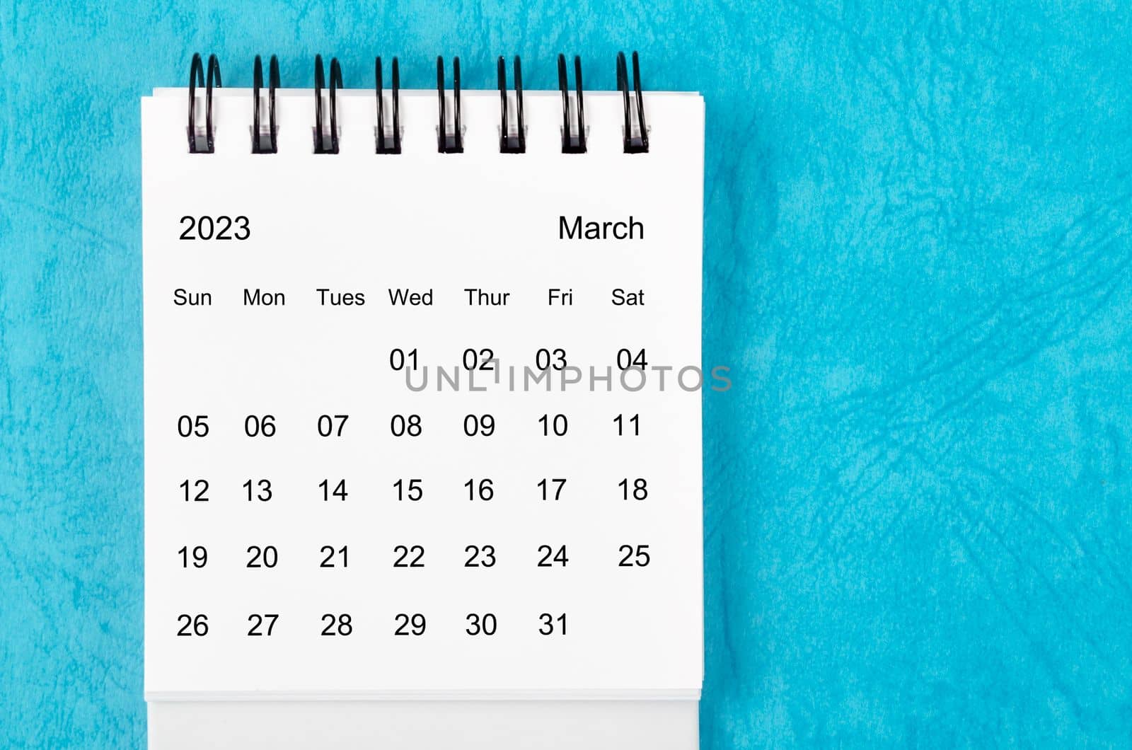 March 2023 Monthly desk calendar for 2023 year on blue background.