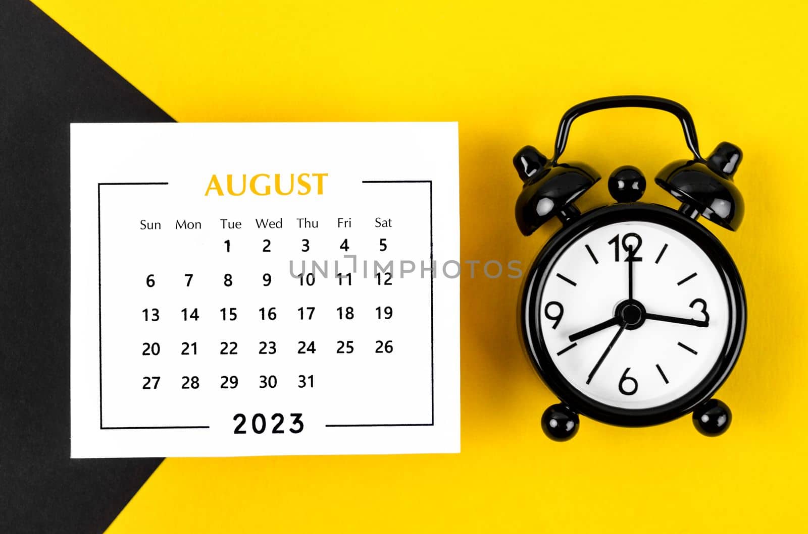 August 2023 Monthly calendar for 2023 year with black colour alarm clock on beautiful background.