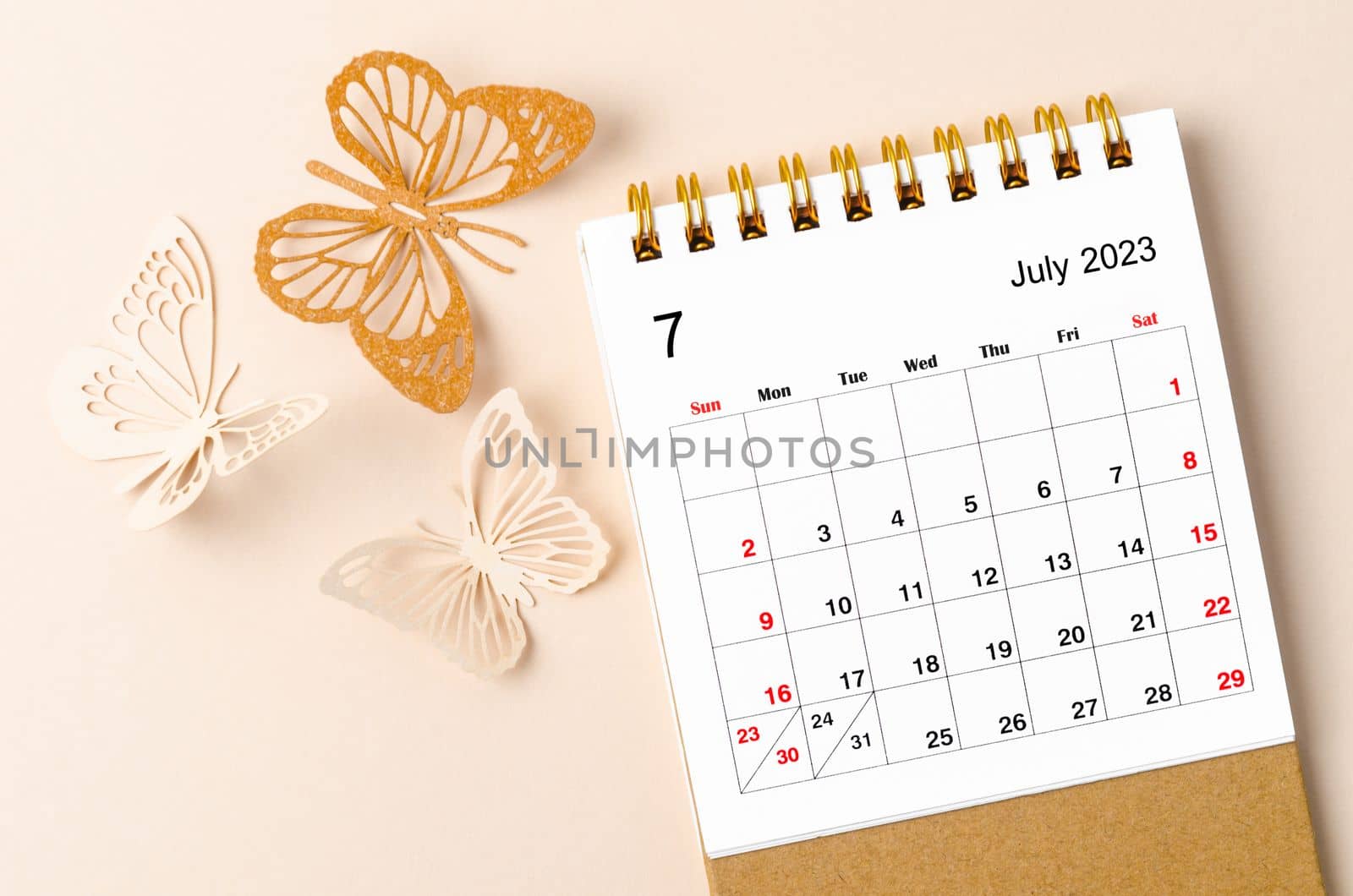 July 2023 desk calendar for the organizer to plan and reminder and butterfly paer on yellow background.