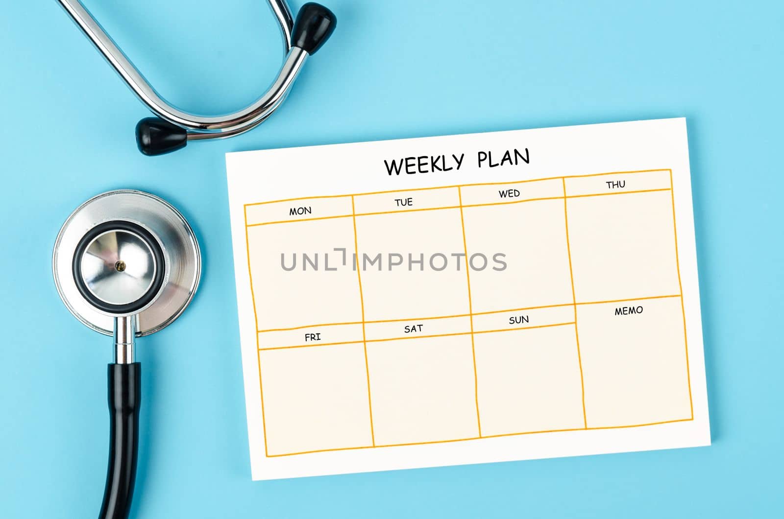 Blank weekly plan notice block and medical stethoscope on blue colour background.