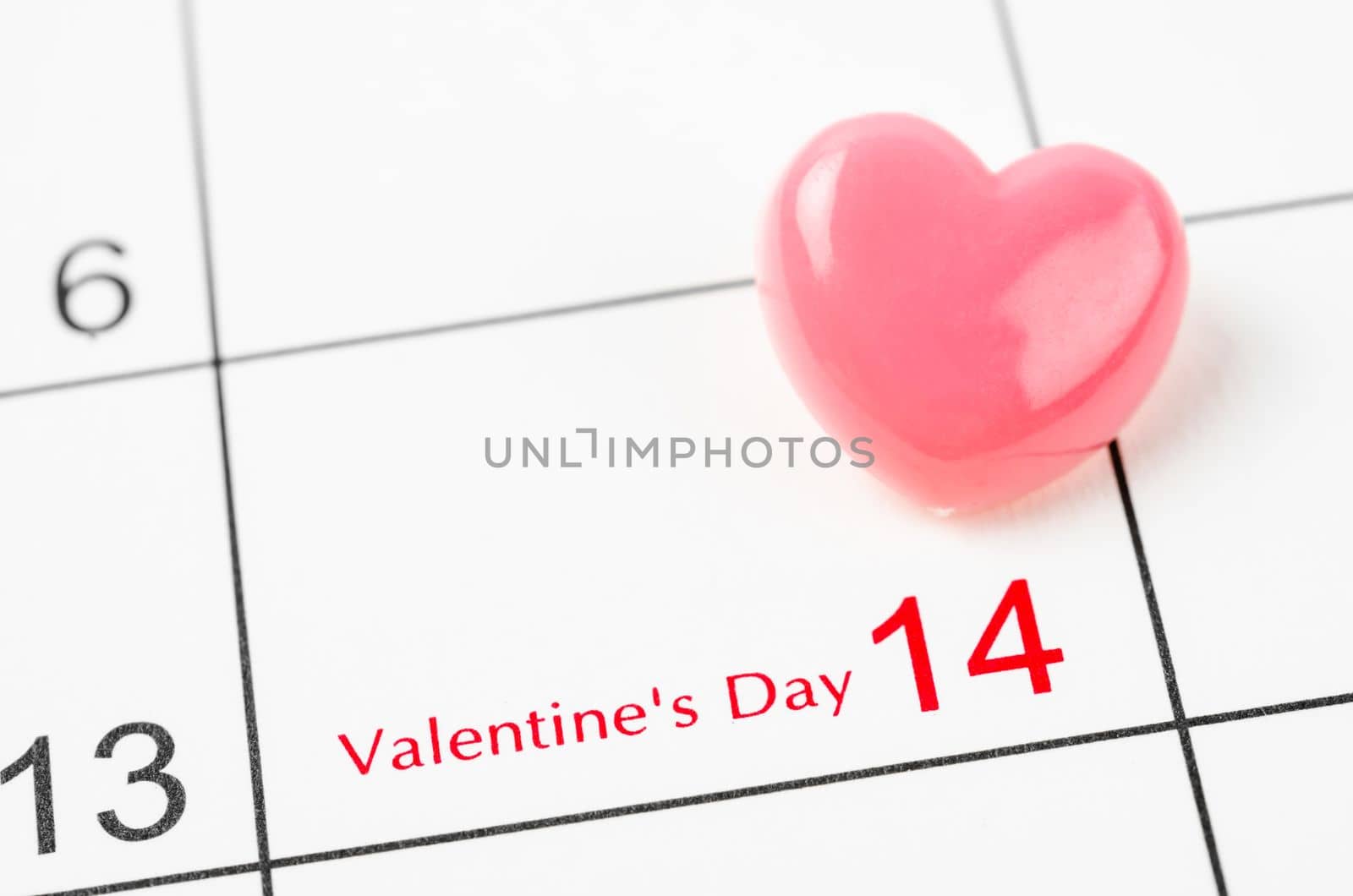 Blank 14 February Valentine's Day Calendar with pink heart push pin.