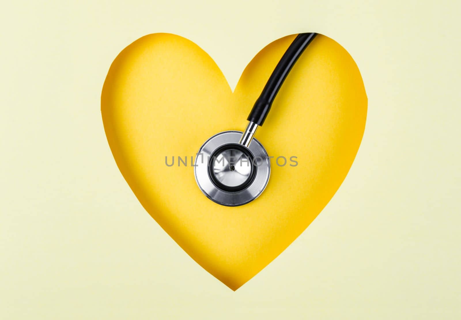 Healthcare Stethoscope Medical on Yellow Background with Paper Heart Shape.
