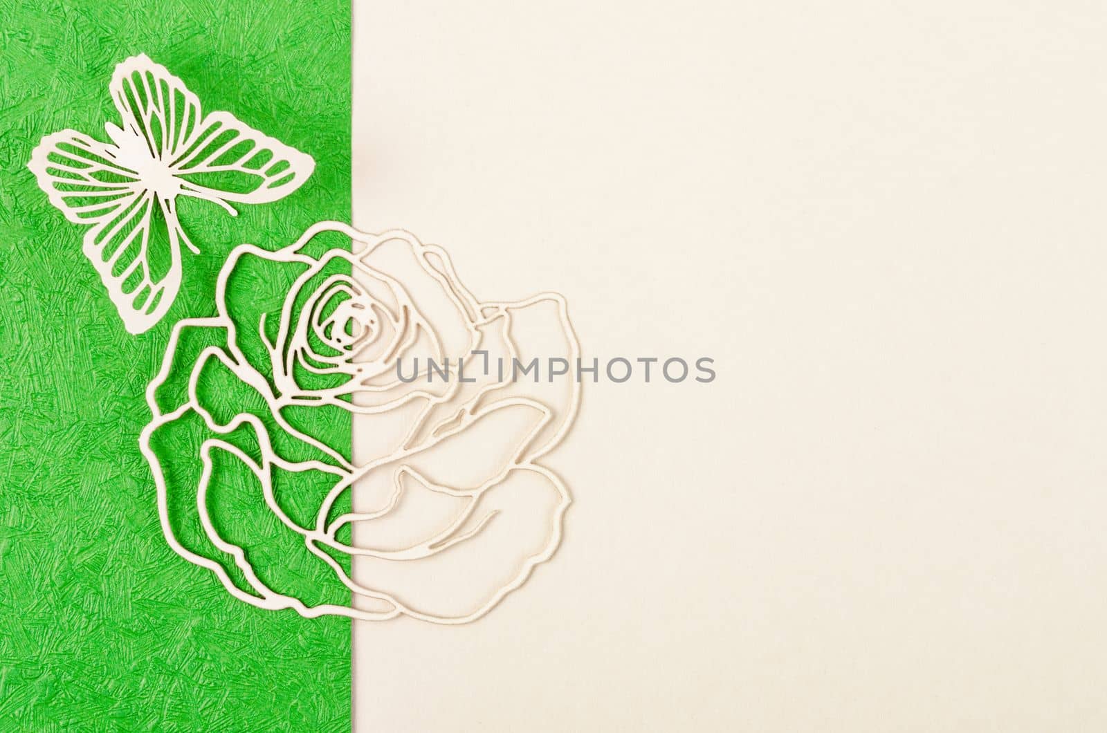 Butterfly and rose flower made from carve paper or cutting on green and yellow background with empty space for your text or message.