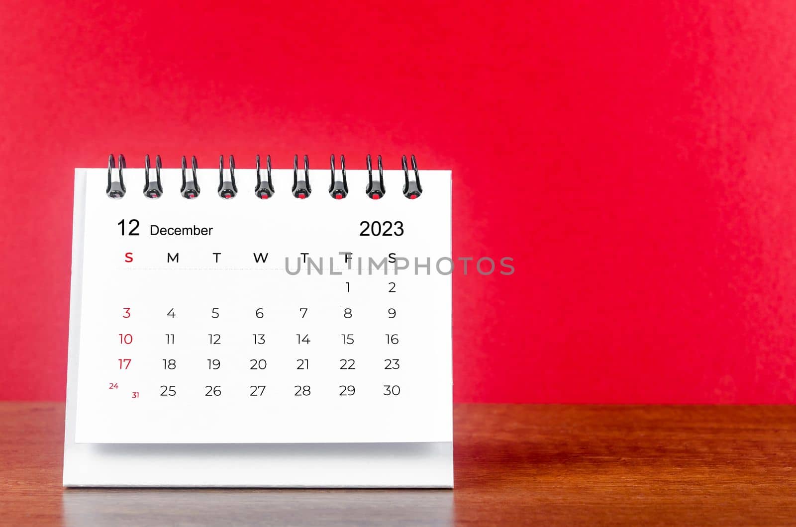 December 2023 desk calendar for 2023 year on Red color background.