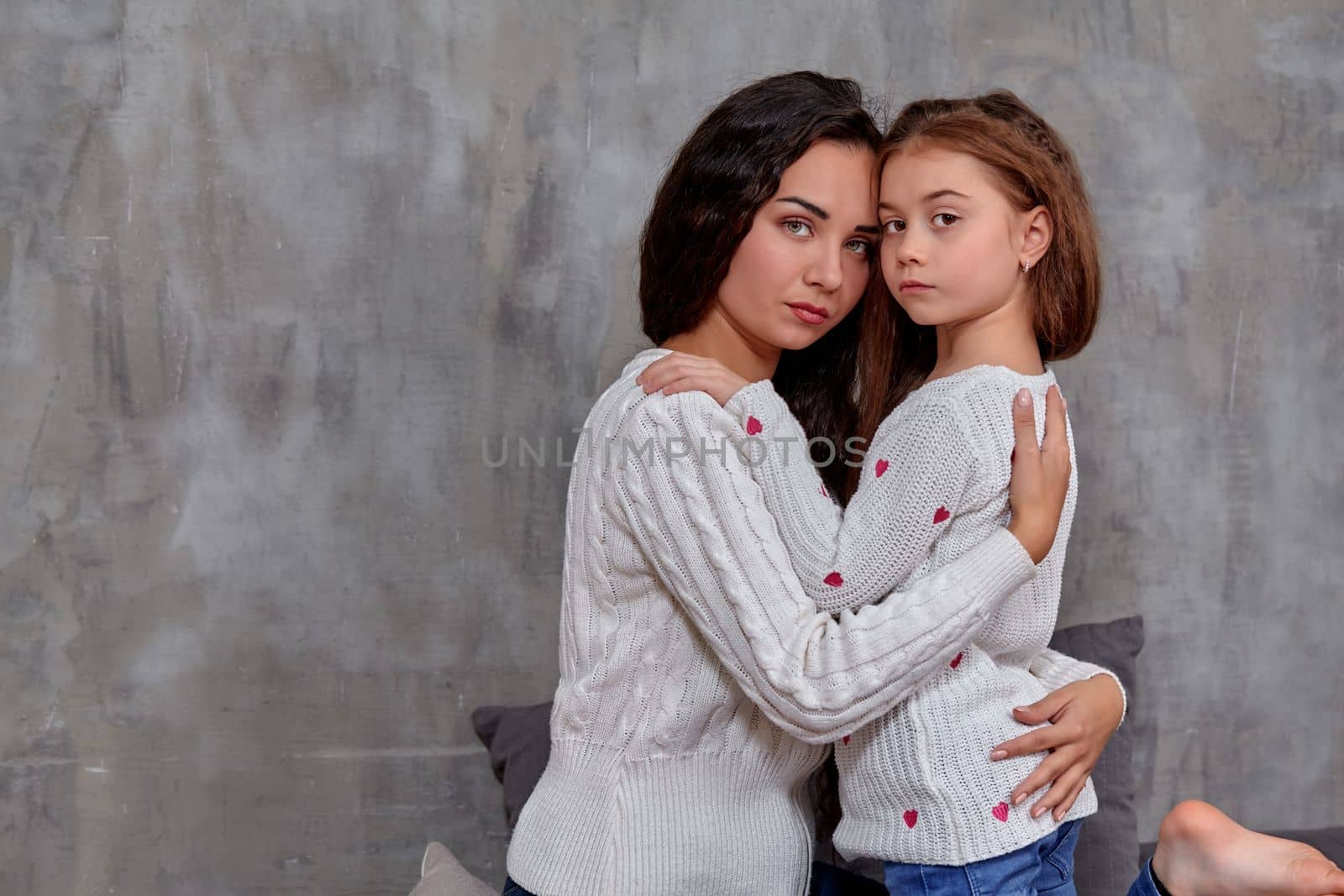 Emotions of a young beautiful mother and her little daughter who spend time together. They show love for each other