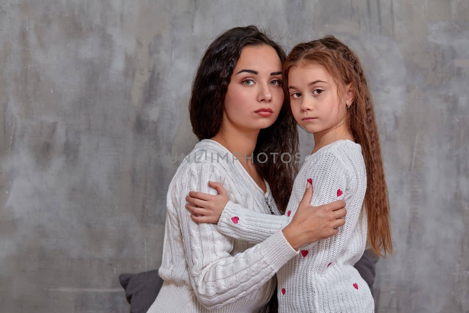 Emotions of a young beautiful mother and her little daughter who spend time together. They show love for each other