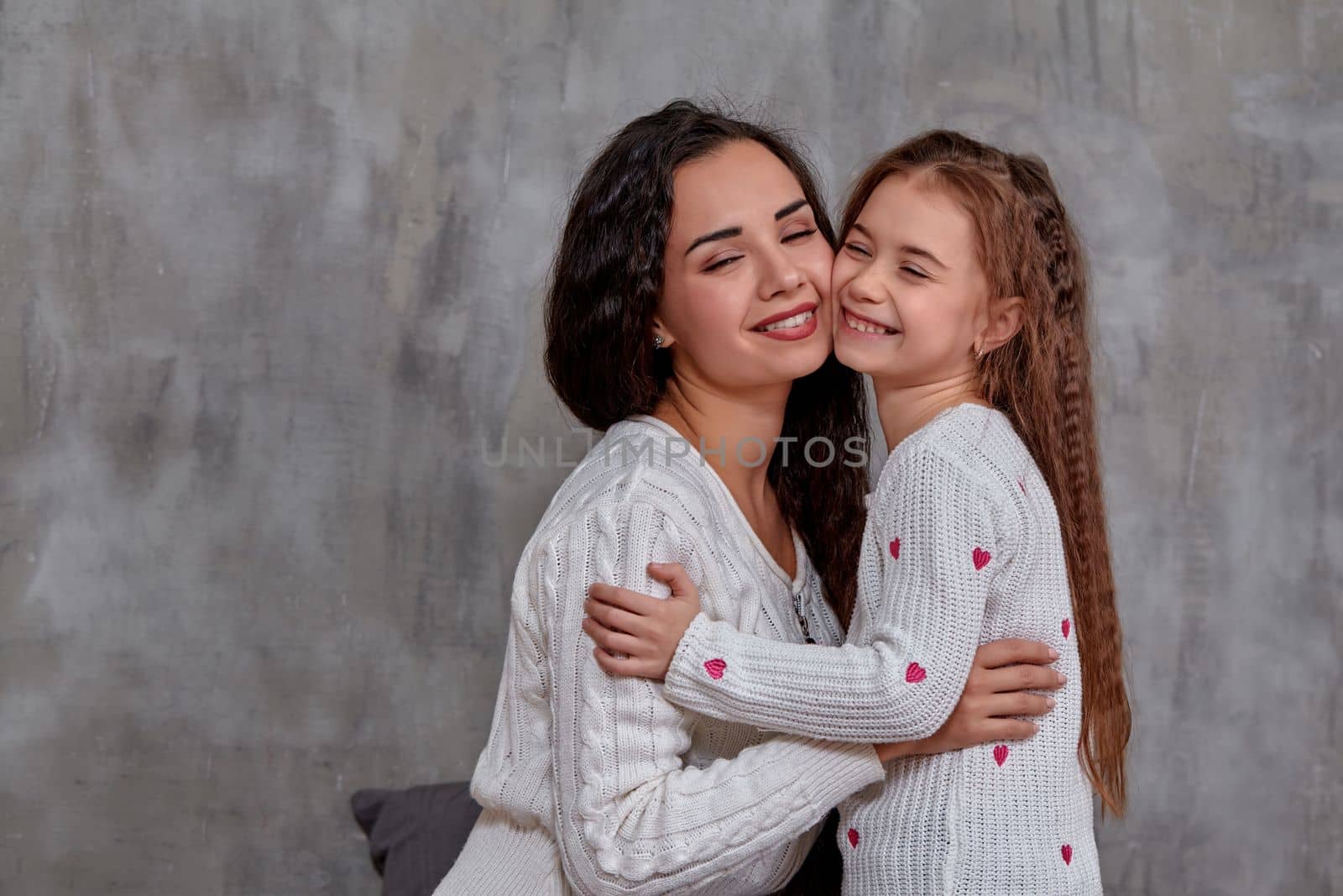 Emotions of a young beautiful mother and her little daughter who spend time together. They show love for each other