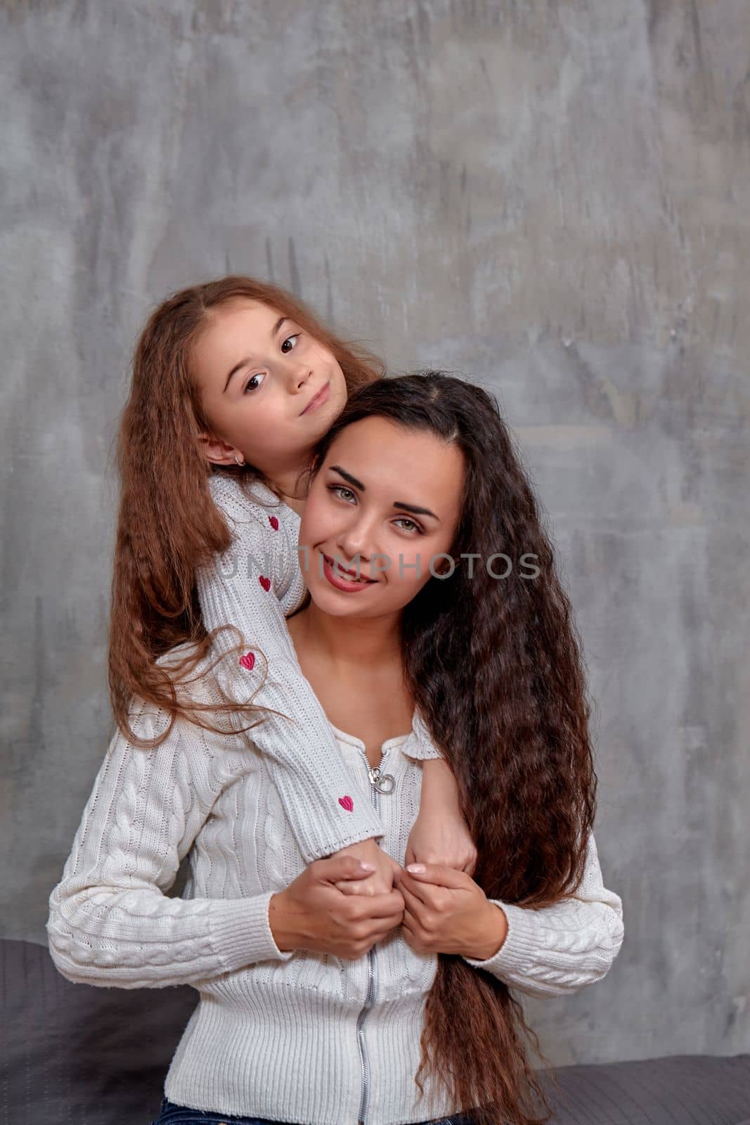 Emotions of a young beautiful mother and her little daughter who spend time together. They show love for each other